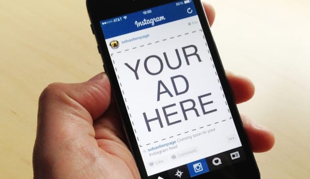 A man holding a phone with an image of your ad here.