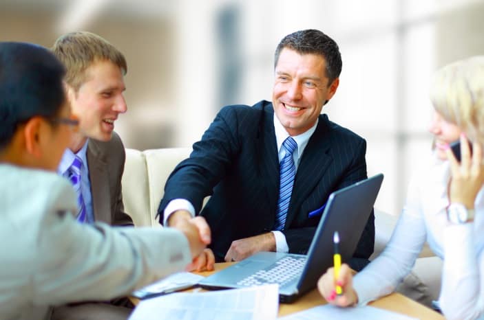 A man giving hand sake with another man after closing the sale.